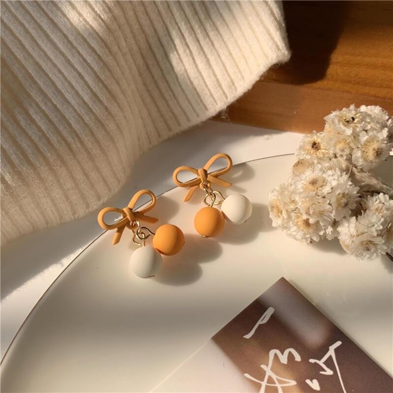 White Tanuki Orange Creme Dessert Bow Earrings